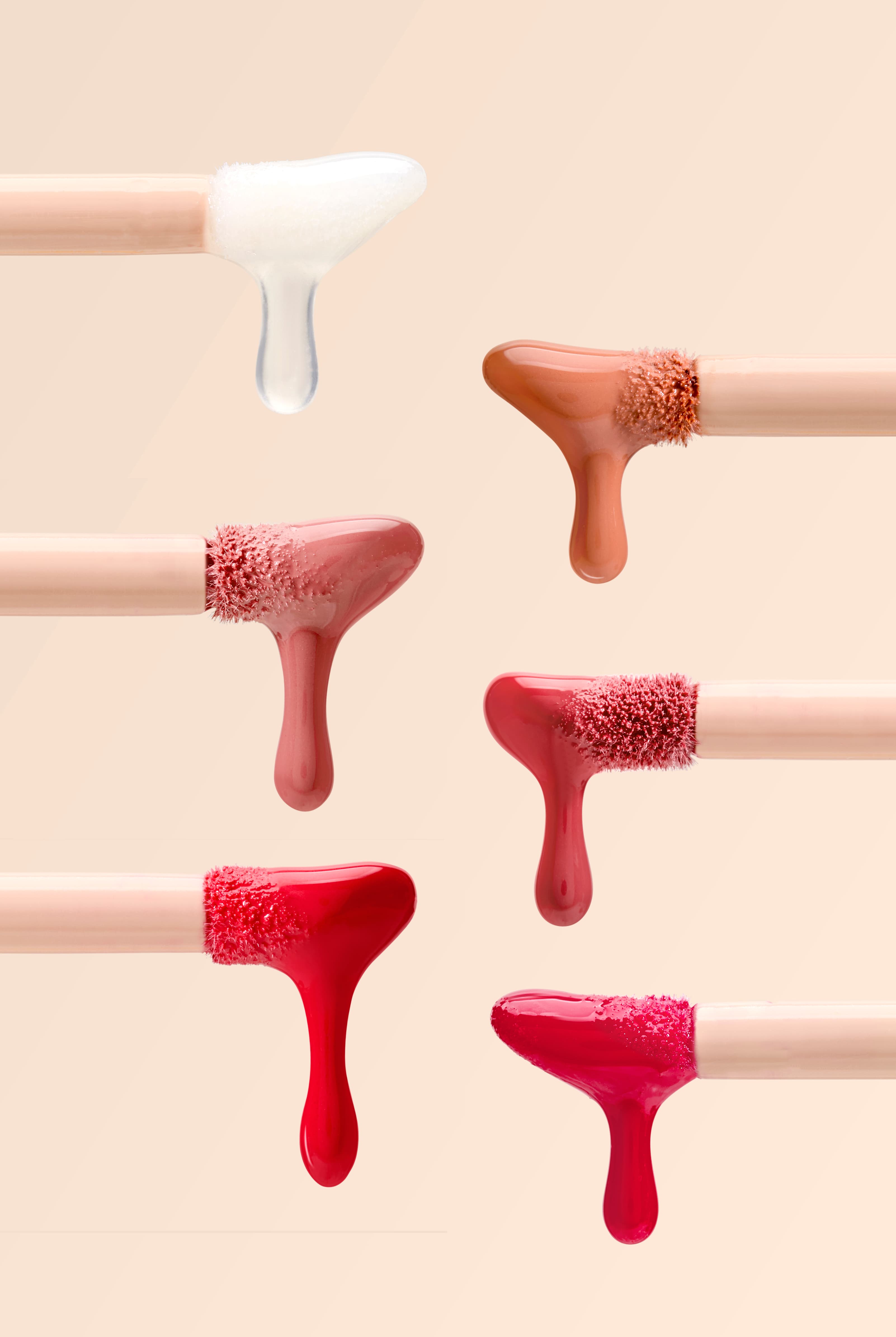 Close-up of Lenoites Tinted Lip Oil applicators in the shades Clear, Classy, Sophisticated, Clever, Bold and Prestigious.